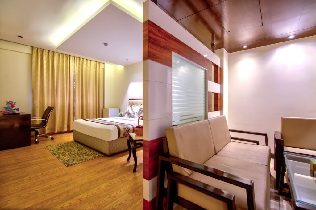 Spacious family suite with bedroom and living area at Hotel GreySky South Delhi